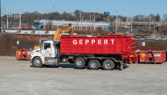 Truck unloading a dumpster