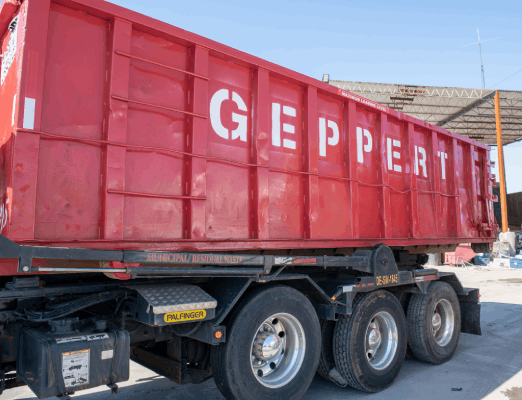 Truck unloading a dumpster