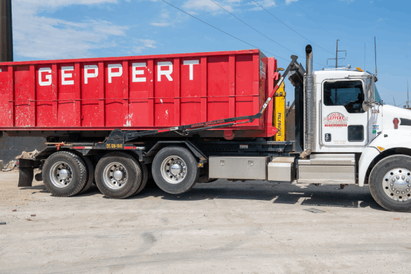 Truck unloading a dumpster